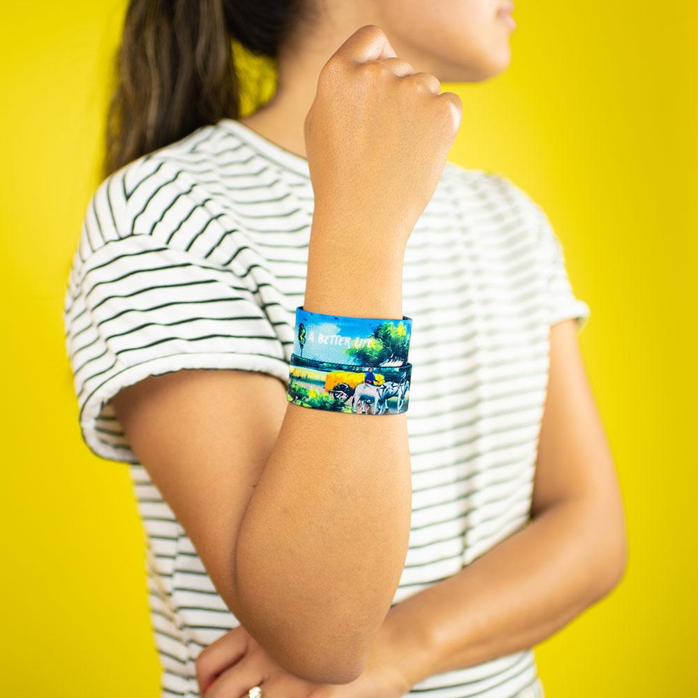 Studio photo of girl wearing two A Better Life wristbands
