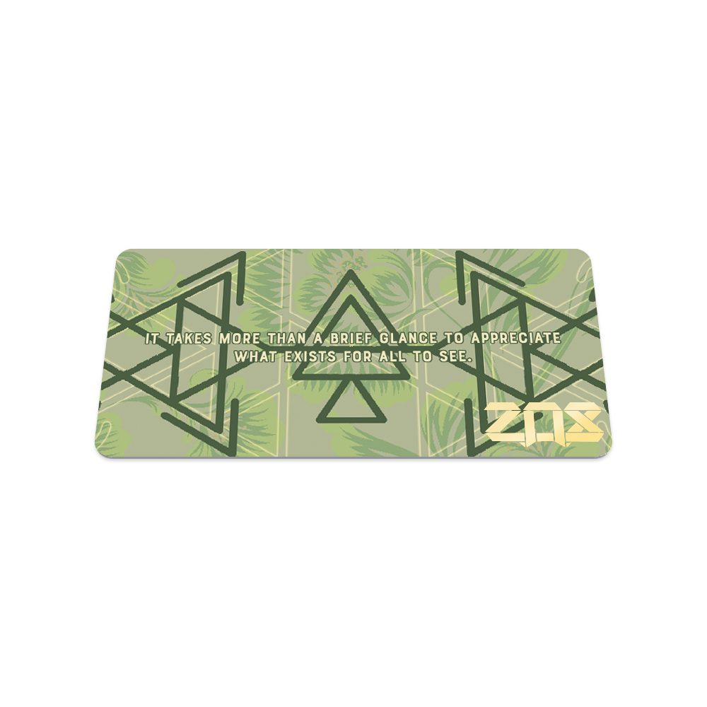 Back collector's card image of Beauty in Disguise, a pale green background with dark green geometric designs and Beauty in Disguise in the center