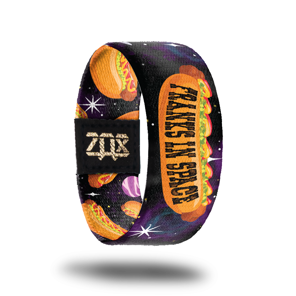 Inside design of Franks In Space. Large cartoon illustrated hotdog in the center with Franks In Space in black text on the bun over a dark space background