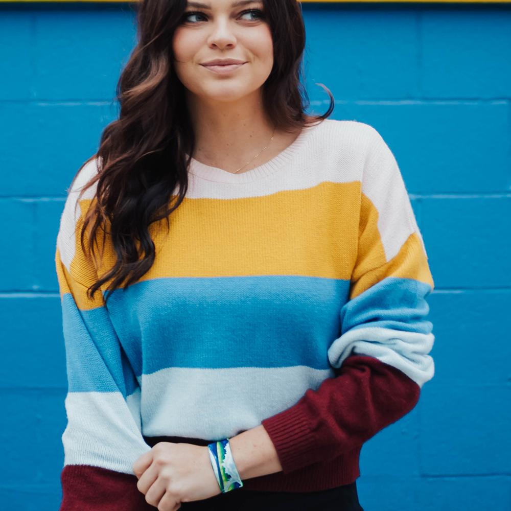Lifestyle image of Relentless on wrist of smiling model