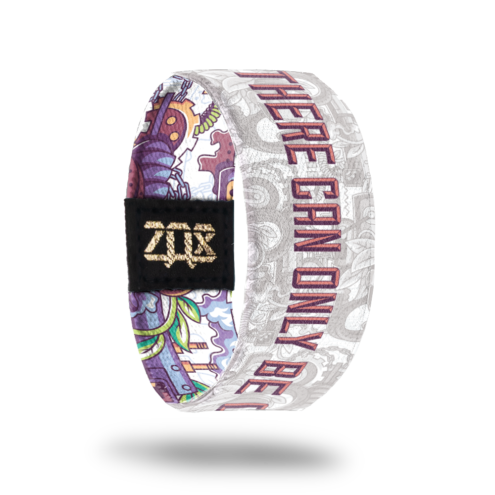 Inside design of elastic wristband called There Can Only Be One. The design says There Can Only Be One in a large font with a grey background consisting of little items such as a helmet, hat, gears, coils, blocks and other miscellaneous items