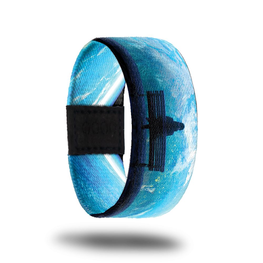 Product photo of the outside of 2020: blue toned design with artwork of a person sitting on a park bench looking at the world from outer space