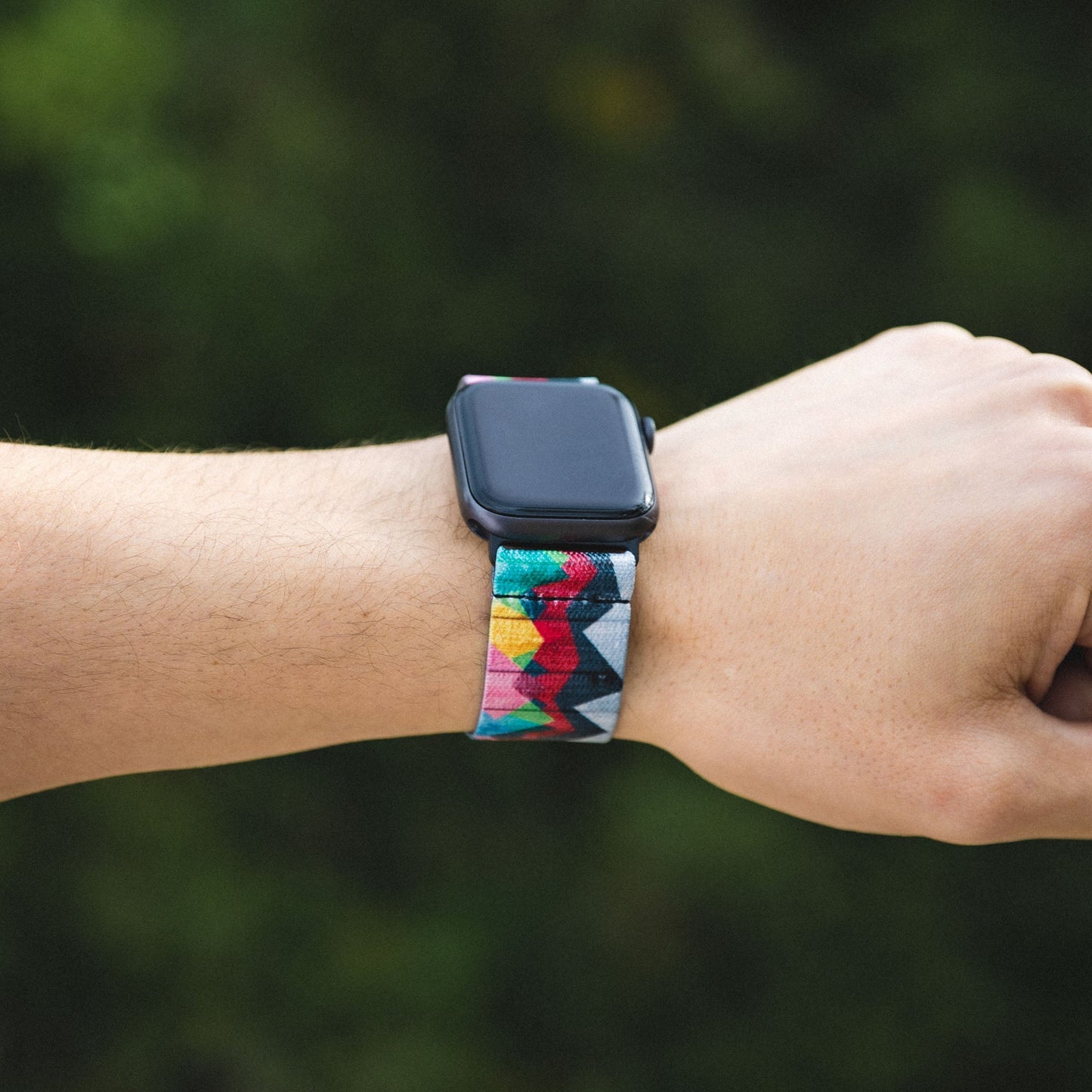 Lifestyle photo of someone's arm, wearing the watchband on an Apple watch. 