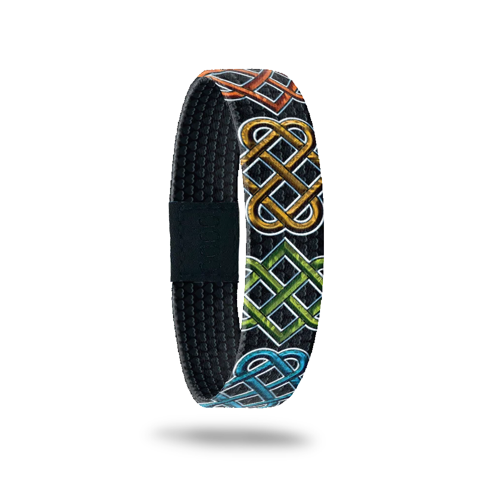 Black base with colored Celtic designs all long. Inside is sold black and reads Anam Cara. 