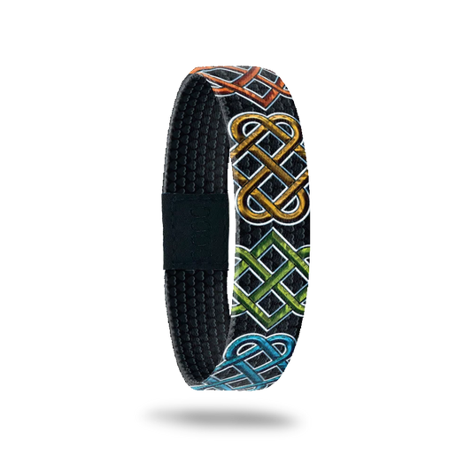 Black base with colored Celtic designs all long. Inside is sold black and reads Anam Cara. 