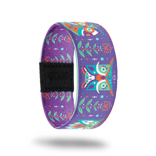 Purple strap with green, orange, white, purple ornate owls all over. Flowers in between each owl. Inside is the same without the owls and says Be Mindful. 