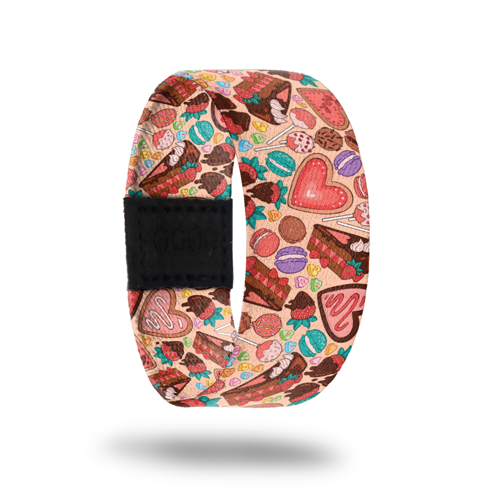 Be Sweet-Sold Out-ZOX - This item is sold out and will not be restocked. Pale pink strap with tons of multicolored desserts- suckers, cookies, pie, macaroons, candy hearts. Inside is the same design and reads Be Sweet To Yourself.  