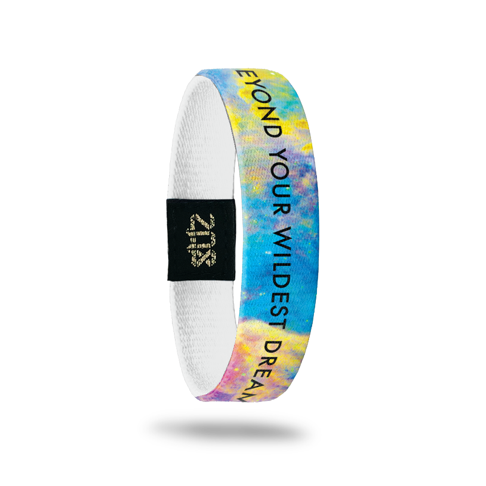 Inside Design of Beyond Your Wildest Dreams: multi-colored galaxy design with black text overlaying ‘Beyond Your Wildest Dreams’