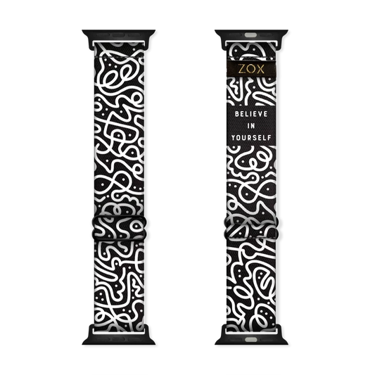 This is a watchband and not reversible. One one side is a black base with white swirls all over. The inside is the same design and reads Believe In Yourself. 