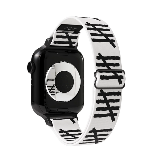 This is a watchband and not reversible. The base color is off-white/light grey. It has tally marks all down the sides of the bands. 