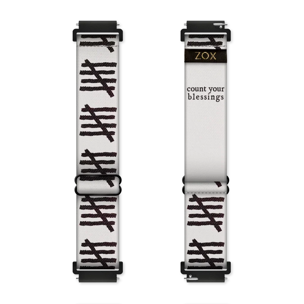 This is a watchband and not reversible. The base color is off-white/light grey. It has tally marks all down the sides of the bands. The inside is the same design and reads Count Your Blessings.