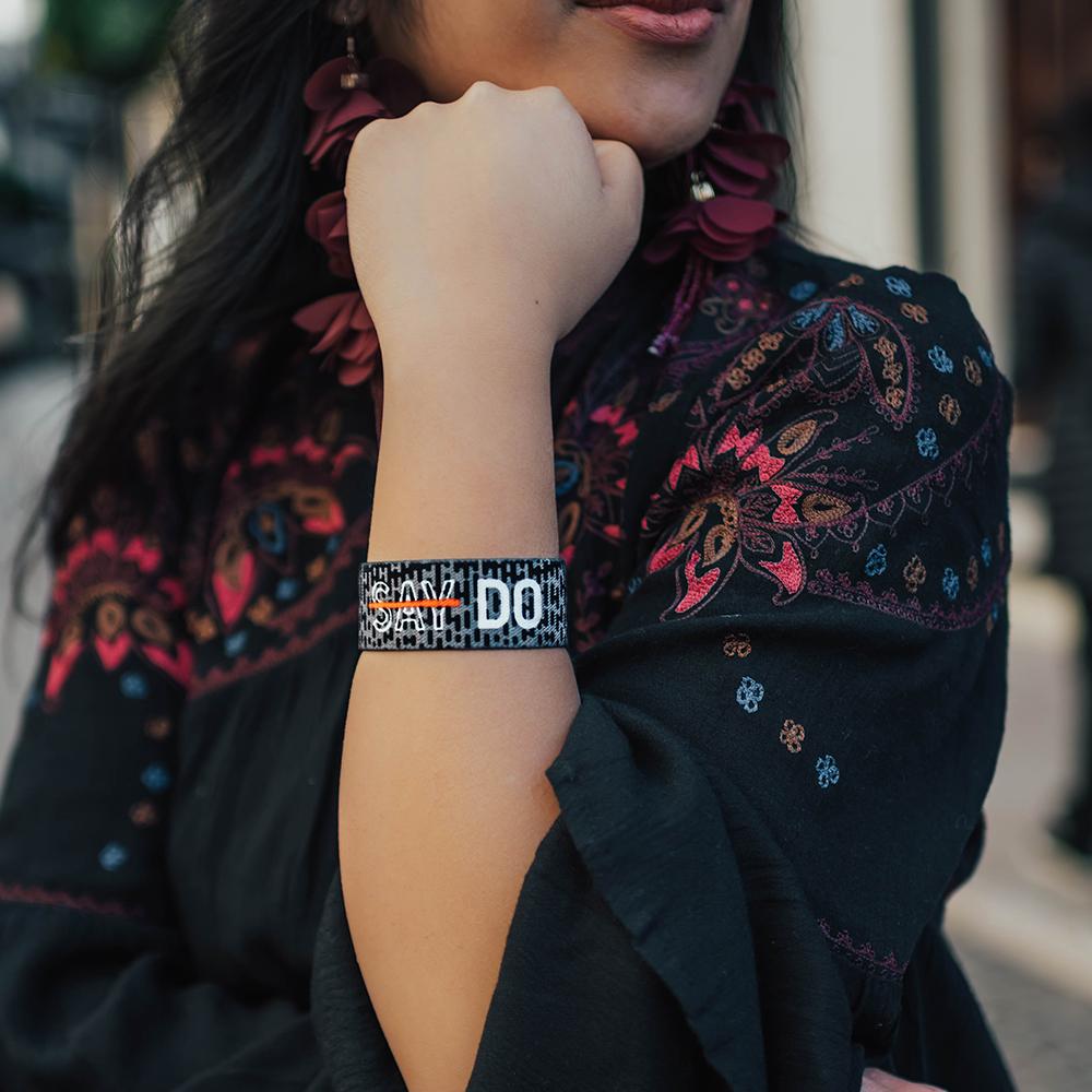 Lifestyle Image of Do on someone's wrist with a scarf in the background