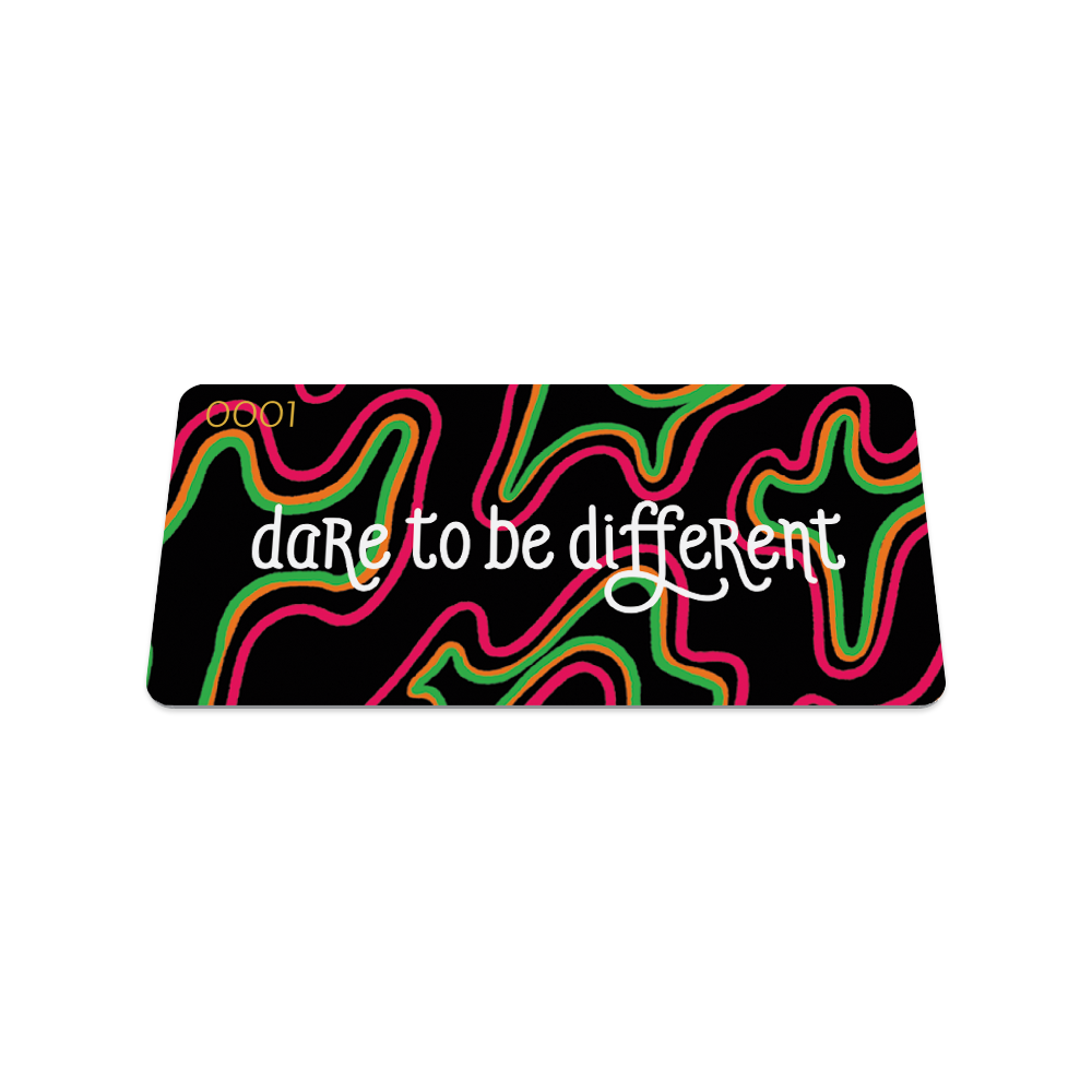 Front collector's card image of  Dare to Be Different: black background with pink, orange and green in irregular shapes throughout the card and text 'Dare to Be Different'