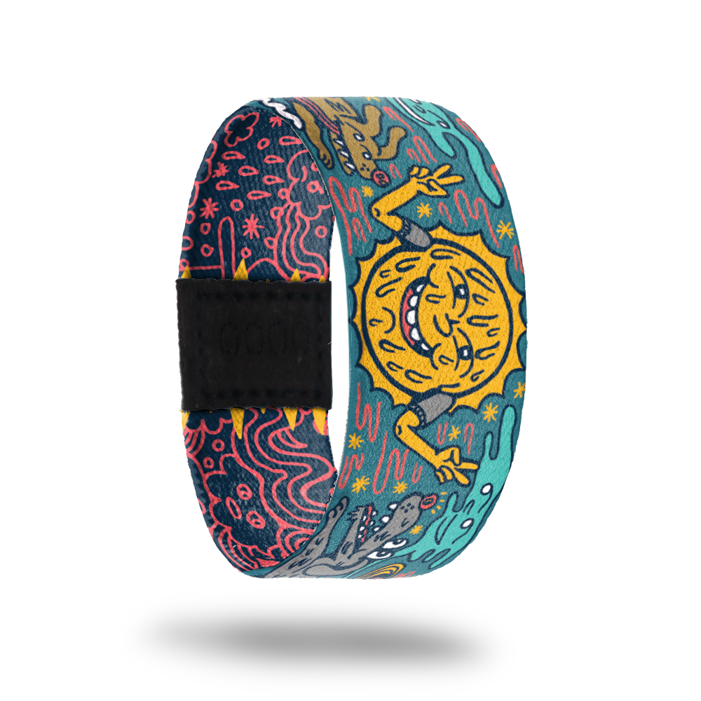 Outside design of Far Out. In the center is a illustrated sun giving the peace sign on both hands. On the sides are illustrated dogs. The background is teal with wiggle lines of pink between the sun and dogs.