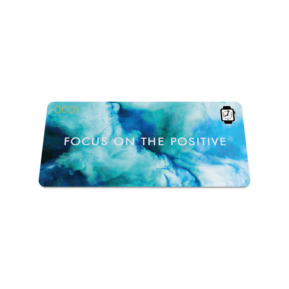 This is the front of the collector's card. The design is multiple blue colors making a smoke effect and in white text it reads "focus on the positive". 
