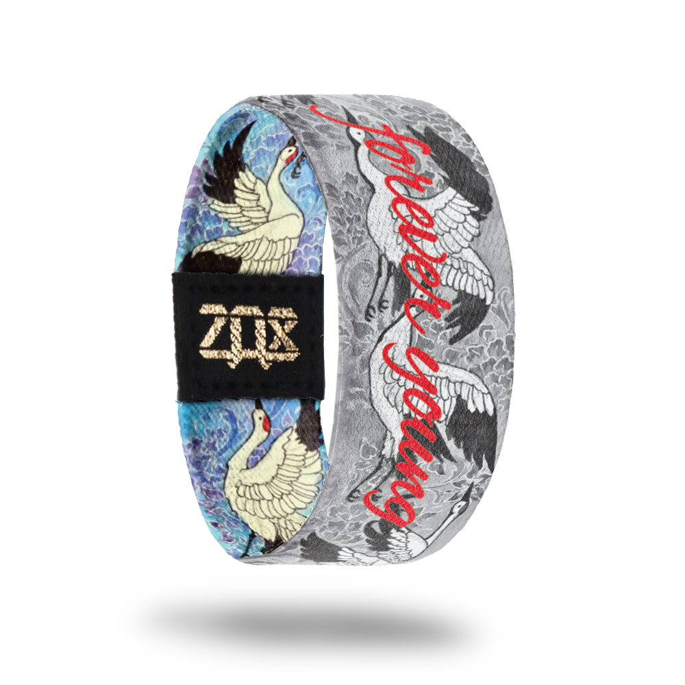 Inside design of Forever Young is a black and grey version of the outside design of the cranes in flight with Forever Young in red text at the center 