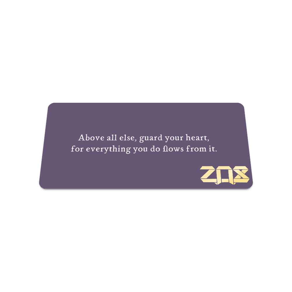This is the back of the collector's card. The design is solid greyish purple and in white text reads "Above all else, guard your heart, for everything you do flows from it."