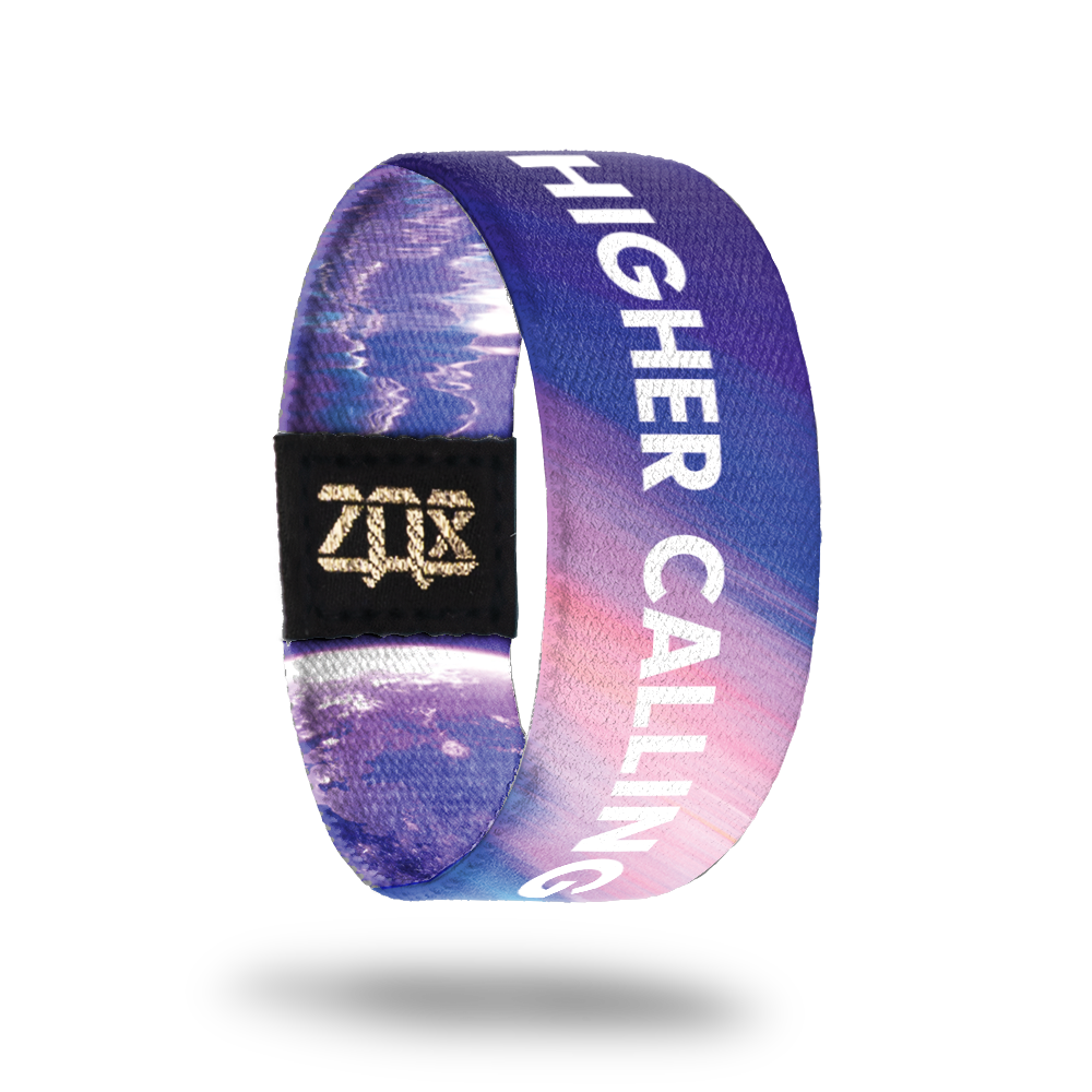 product image of the inside of a wristband named Higher Calling. It is mainly different hues of purple and is an astronaut in space on the outside of it