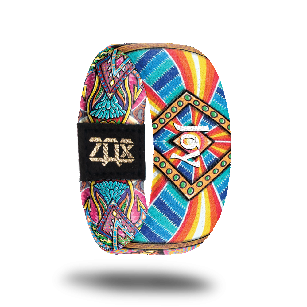 Inside Design of Joy, a colorful geometric design in the unique style of artist Chris Dyer with Joy in white text in the center of the design 