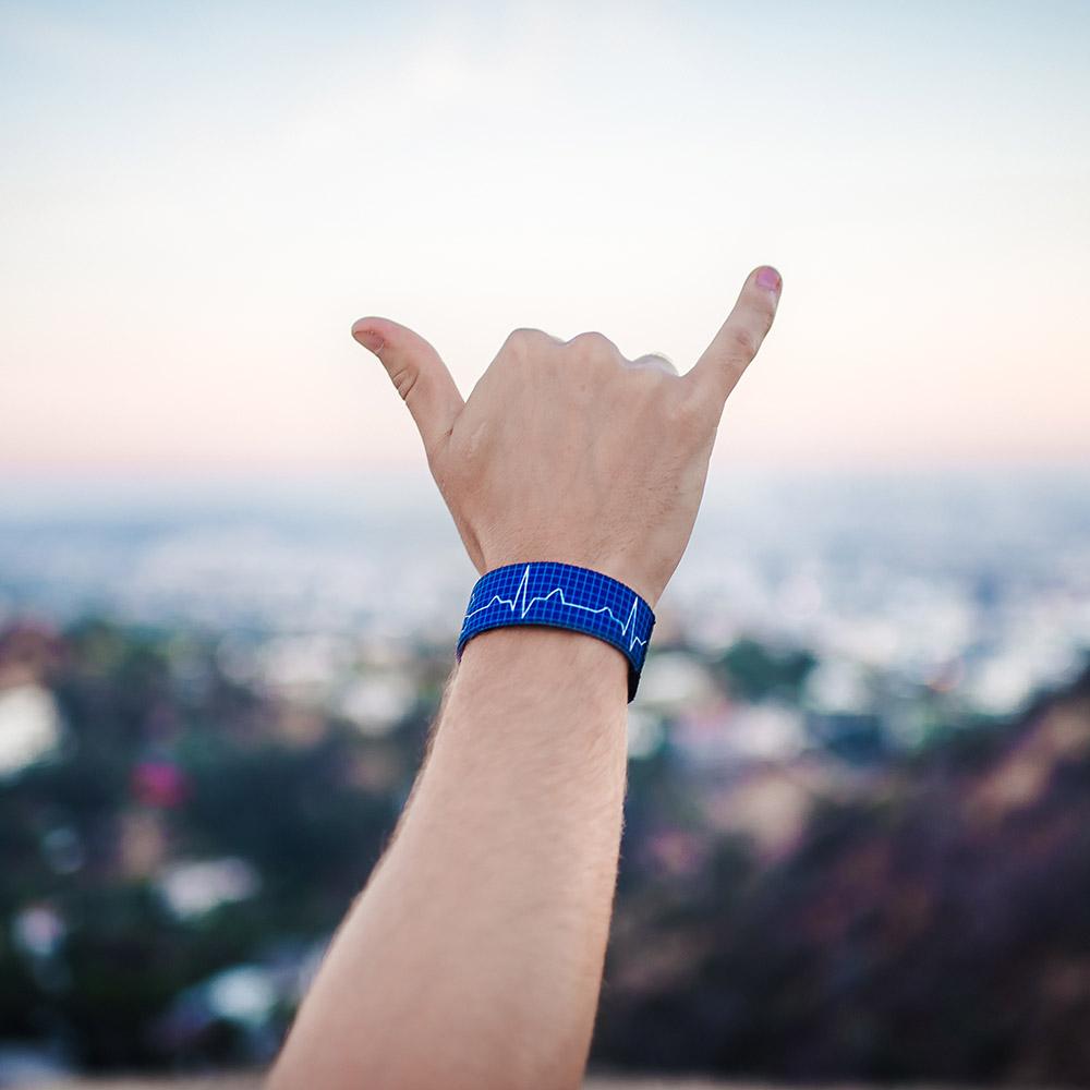 Lifestyle image of hand giving the hang loose sign with Life Saver on wrist 