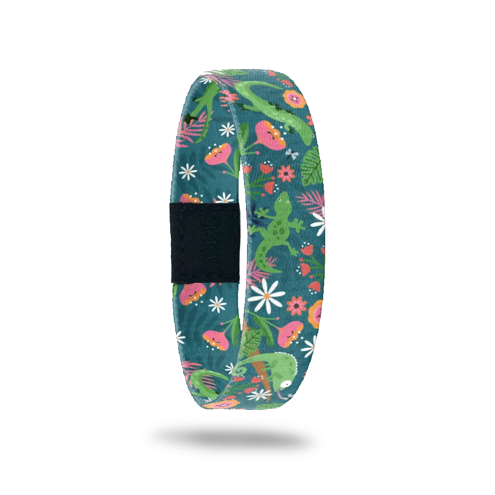 Wristband single is a dark green base. The design is bright green lizards in a mix of pink nd oranges flowers and vines.  The inside is the same and reads Leaping Lizards. 