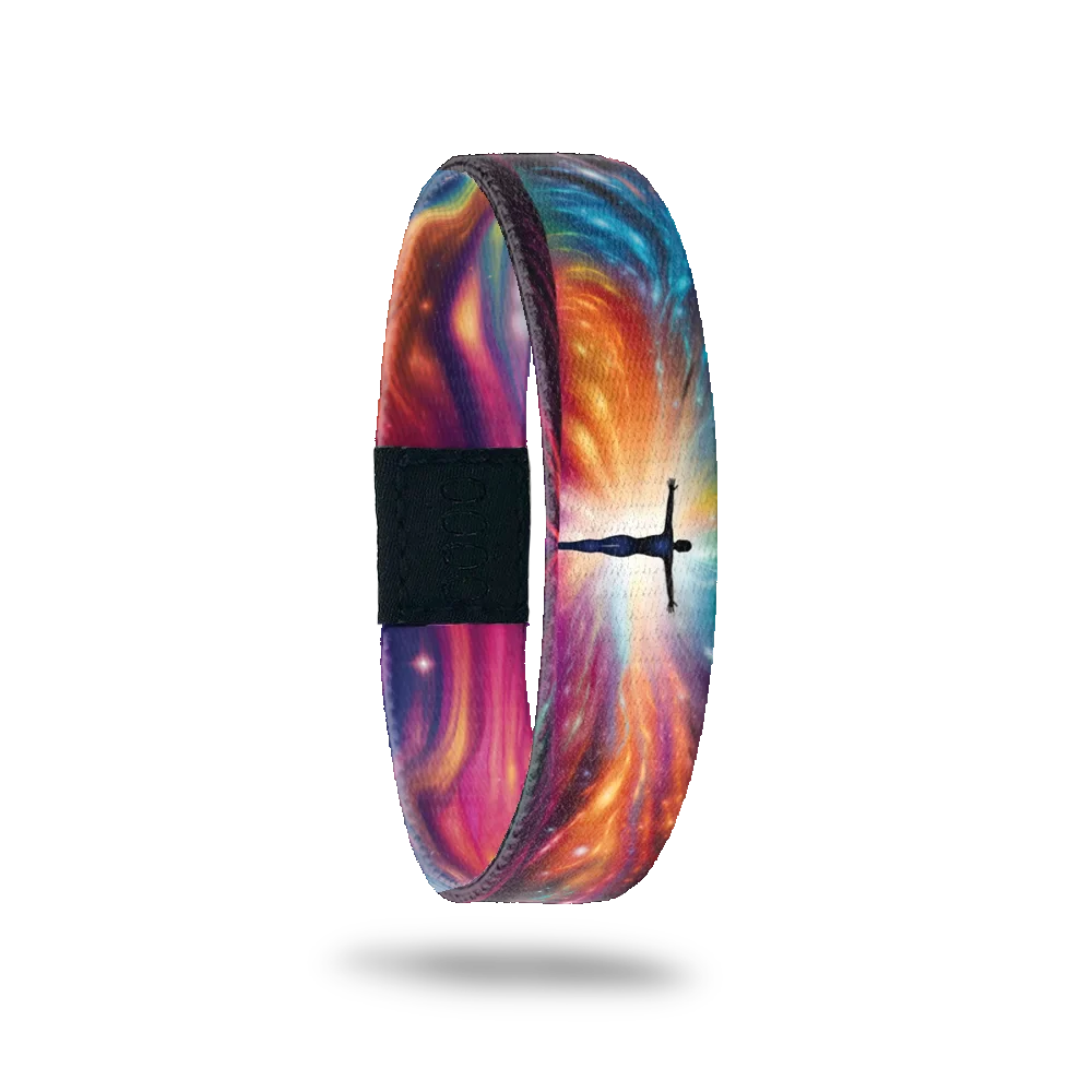 Wristband single is a multicolored gradient that resembles sun rays or a nebula design. In the center of the rays is the sillhouette of a human with arms outstretched and glowing. The inside is the same and reads Leap Of Faith. 