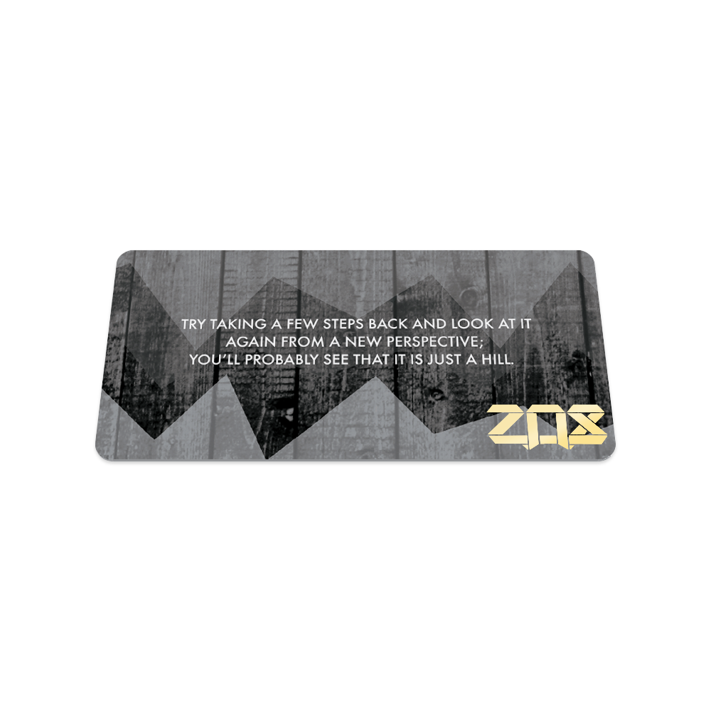 Back of collector's card which is a monochromatic of the same front design. In white text, the quote is "Try taking a few steps back and look at it again from a new perspective; you'll probably see that it is just a hill."