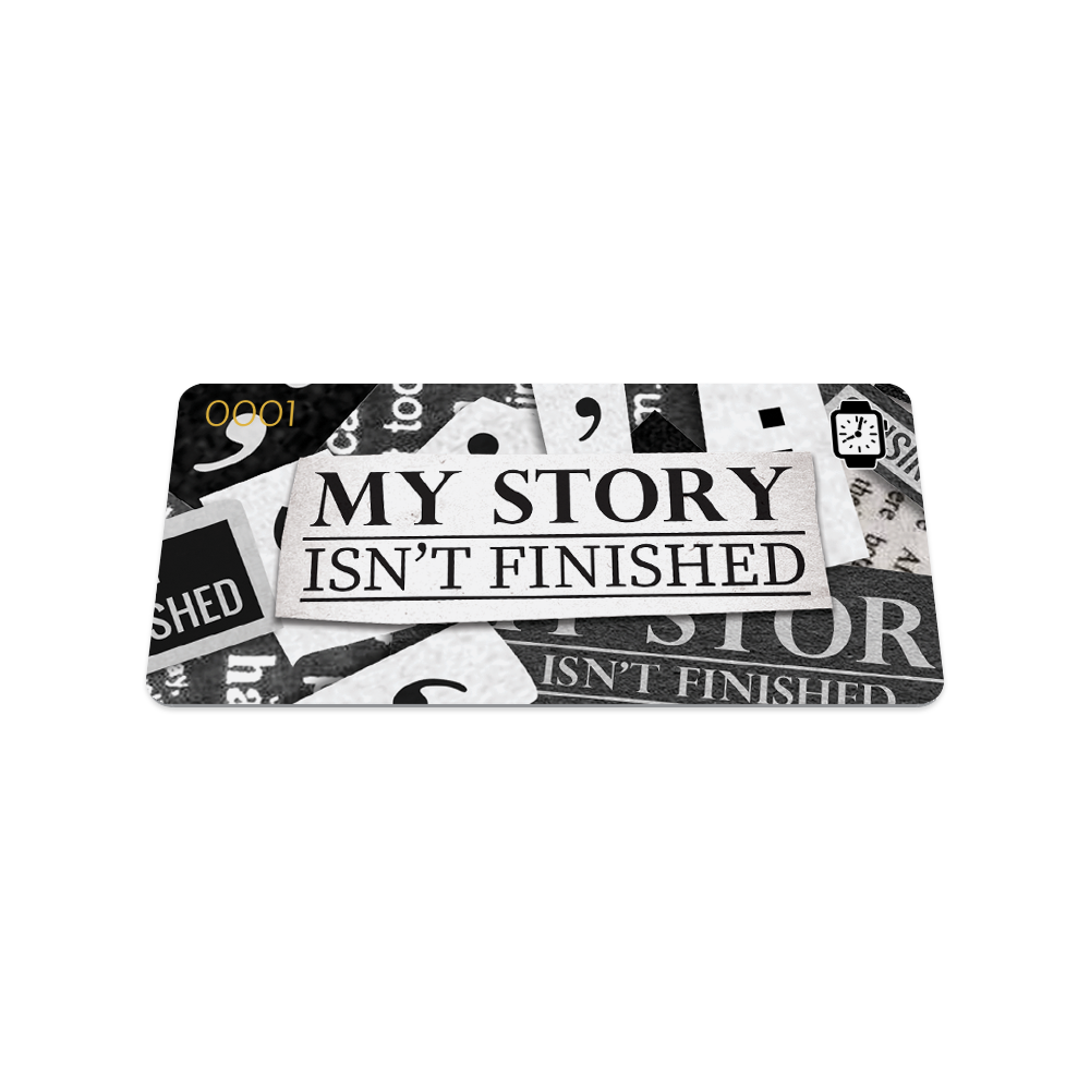 Front of the collector's card. It's a closeup of black and white newspaper clippings all placed over each other like a collage. The text is black and says My Story Isn't Finished. 