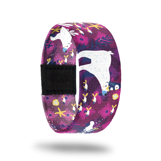 Outside is purple and pink flowers with polar bears carrying penguins on their head and swimming with fish. Inside is the same design and reads "Play Nice".