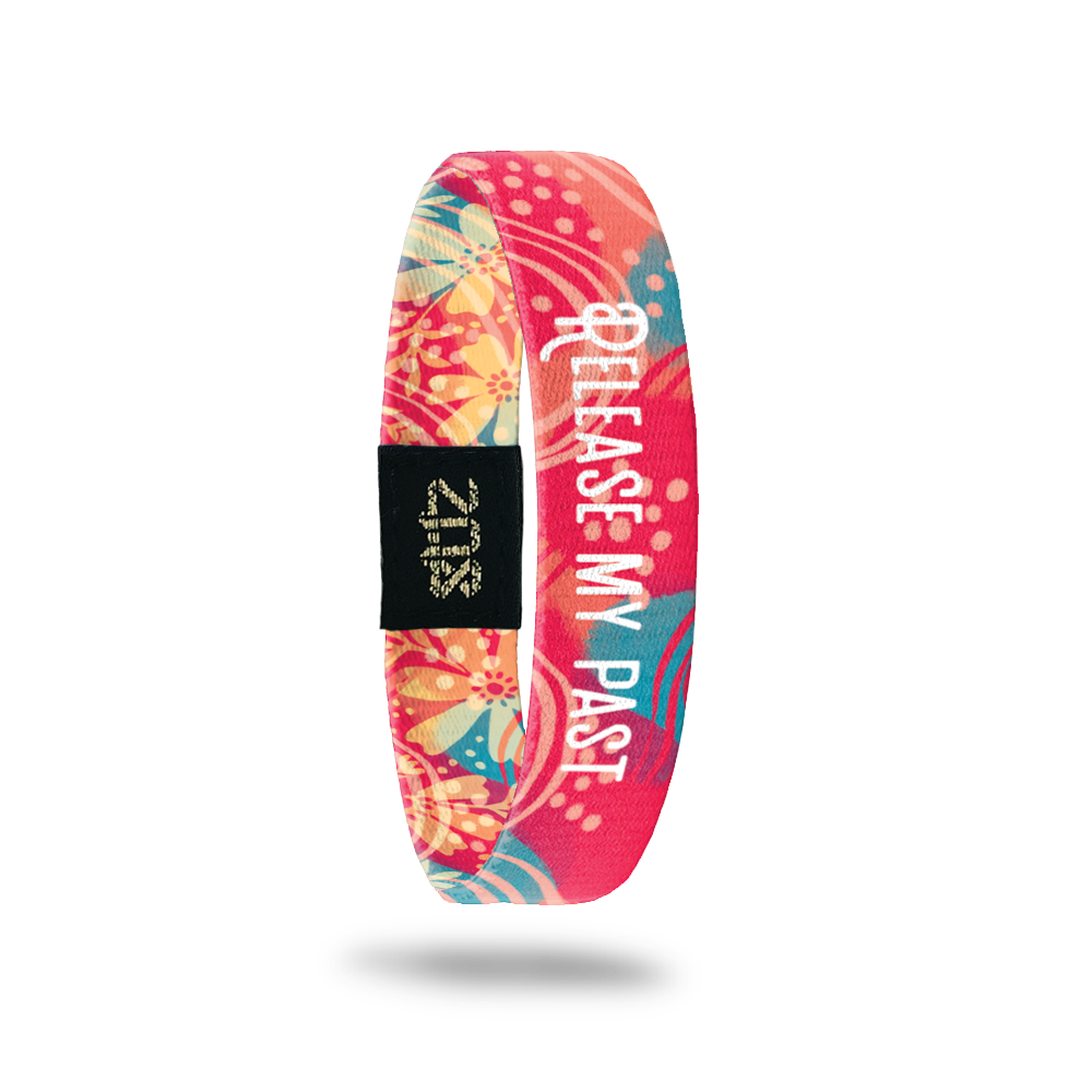 Product photo of the inside of release my past. It is a bright coral background with teal leaves with light coral lines and a white text release my past overlaying.