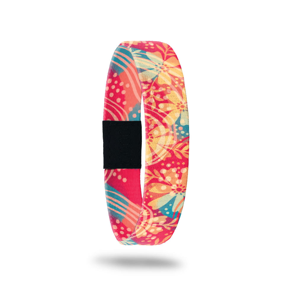 Product photo of the outside of release my past. It is a bright coral background with a yellow floral design with teal leaves.