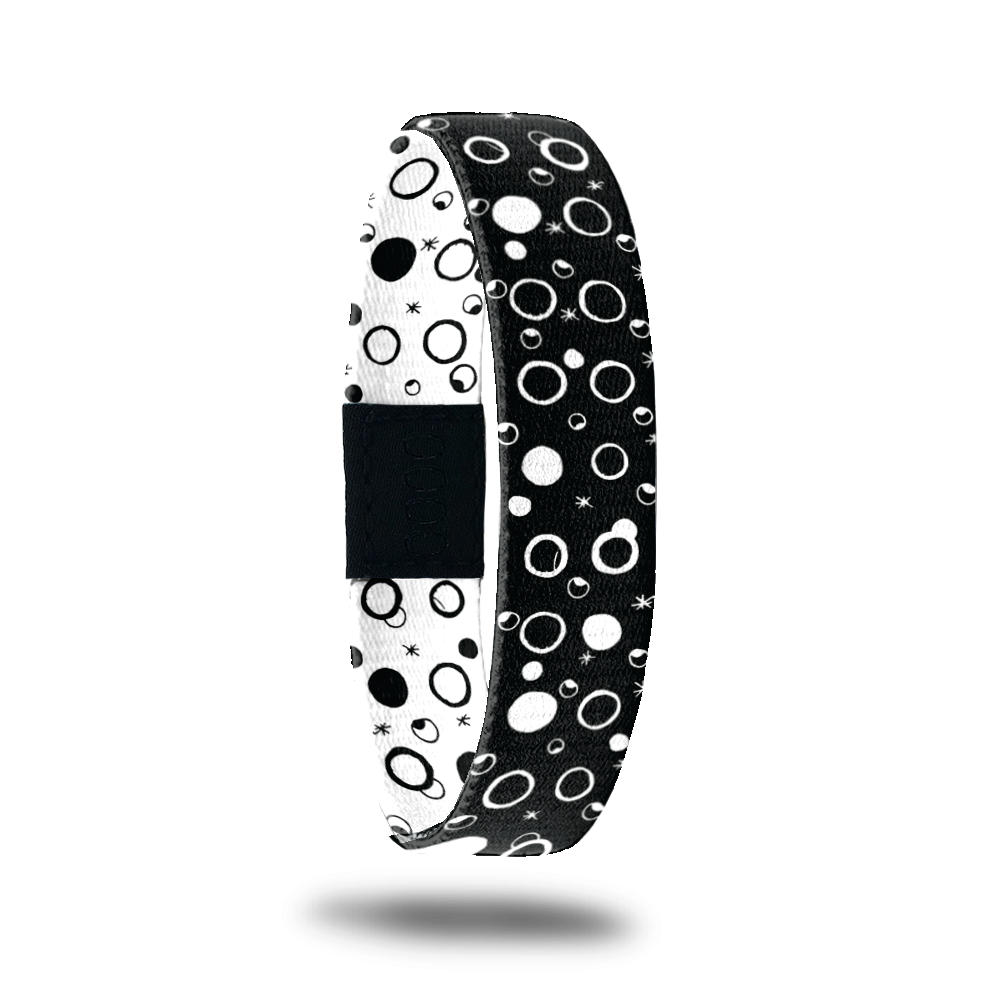 Outside design for Take A Chance. Black background with white filled and outlined circles 