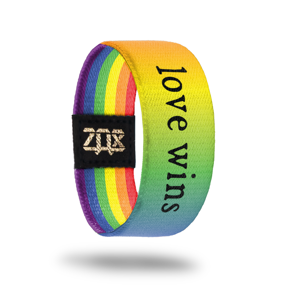 Inside Design of Love Wins: rainbow gradient with black text ‘Love Wins’ on strap