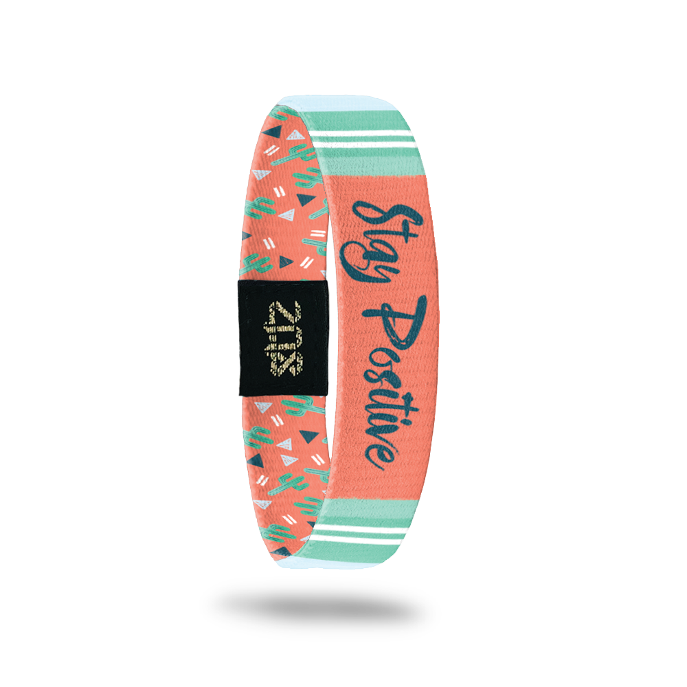 Inside design for Stay Positive. Centered is a orange rectangle with Stay Positive in navy blue text surrounded by teal colors in the background 