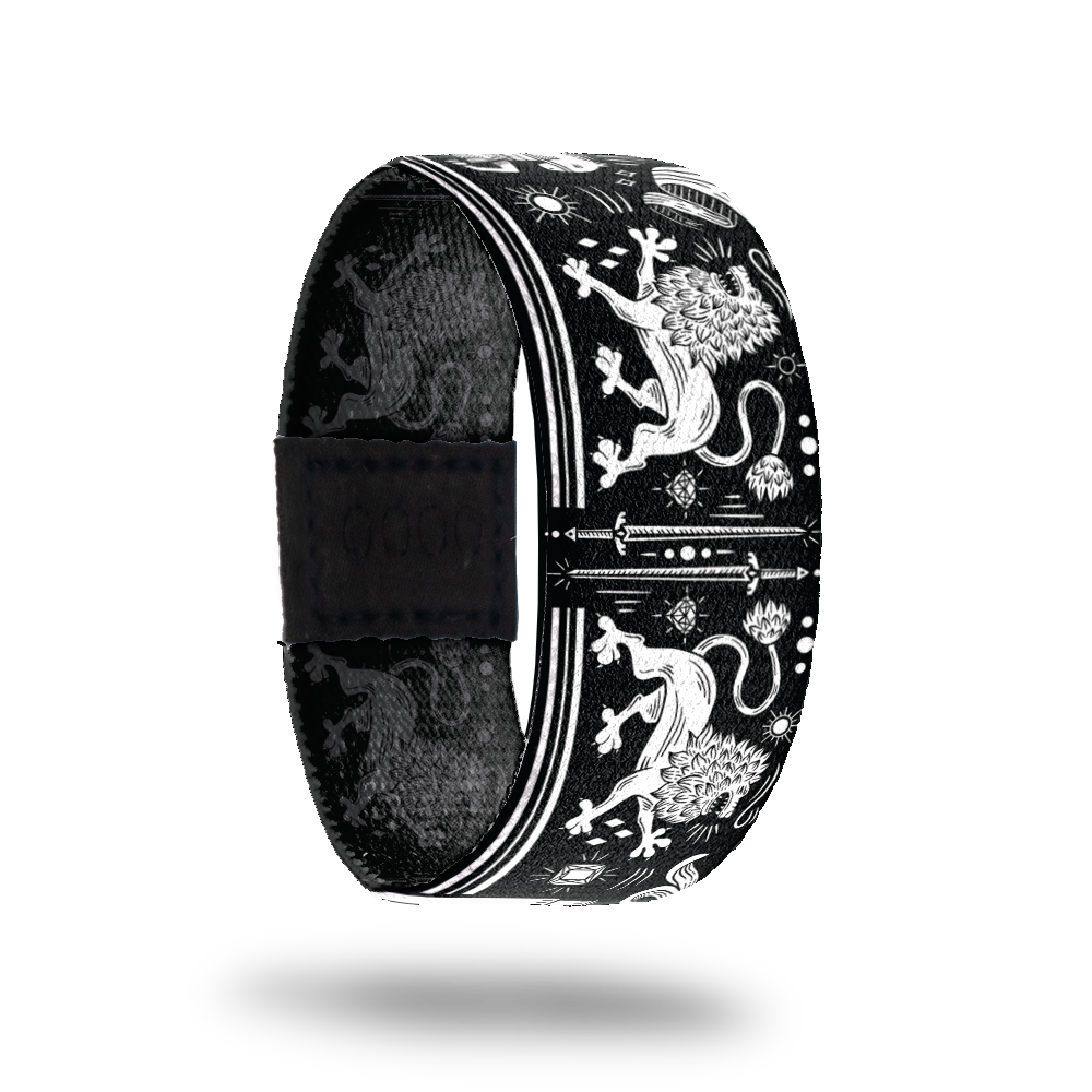 Outside Design of Stay the Course: black design with white lions, swords, diamonds and gems, suns, and knights on horses
