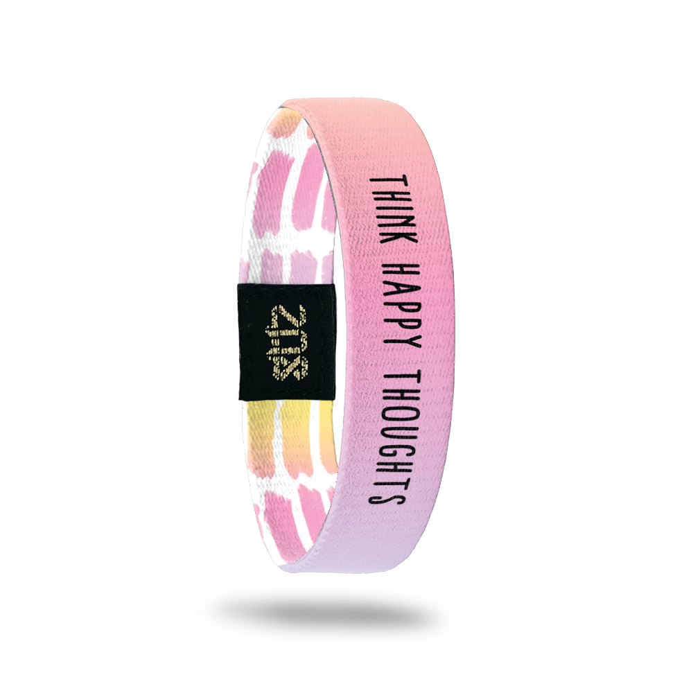 Inside Design of Think Happy Thoughts: watercolor gradient of orange, yellow, pink, purple, and blue background with black text overlaying ‘Think Happy Thoughts’