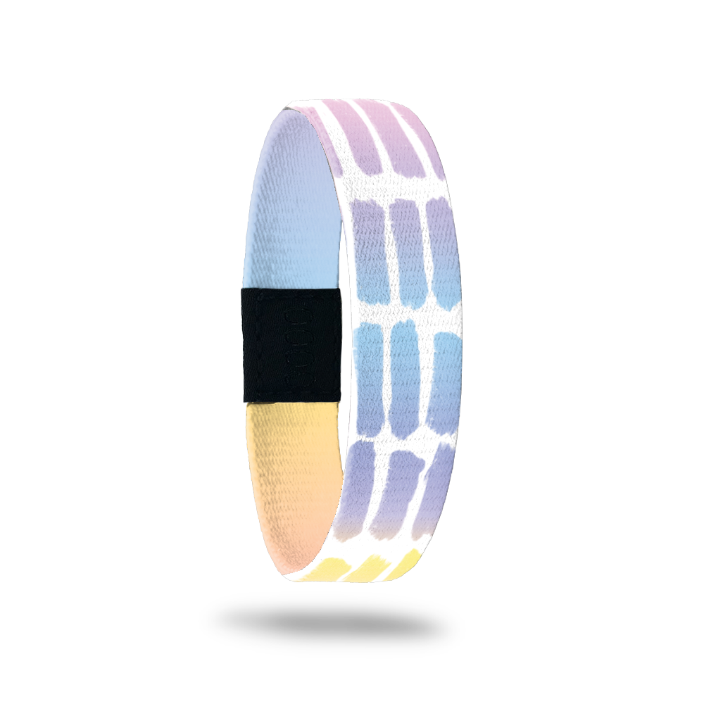 Outside Design of Think Happy Thoughts: white background with geometric pattern of painted watercolor patches that are a gradient of orange, yellow, pink, purple, and blue