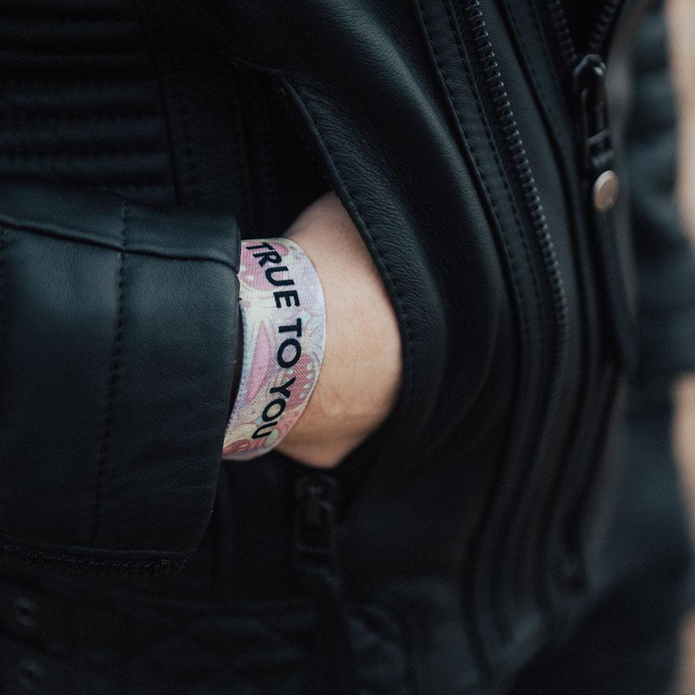 Lifestyle image of someone's hand in jacket pocket wearing True To You