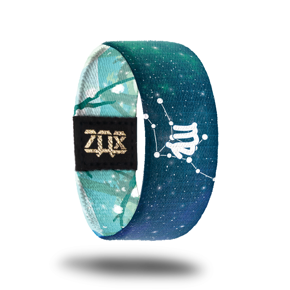 Inside design shows the Virgo symbol in the center of the strap while also having the astrological star formation behind it. Background is a blueish green tone with white dots symbolizing stars all over it.