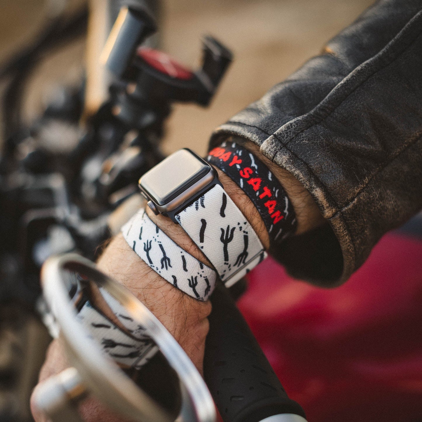 Closeup of someone wearing the wristbands and the watchbands. 