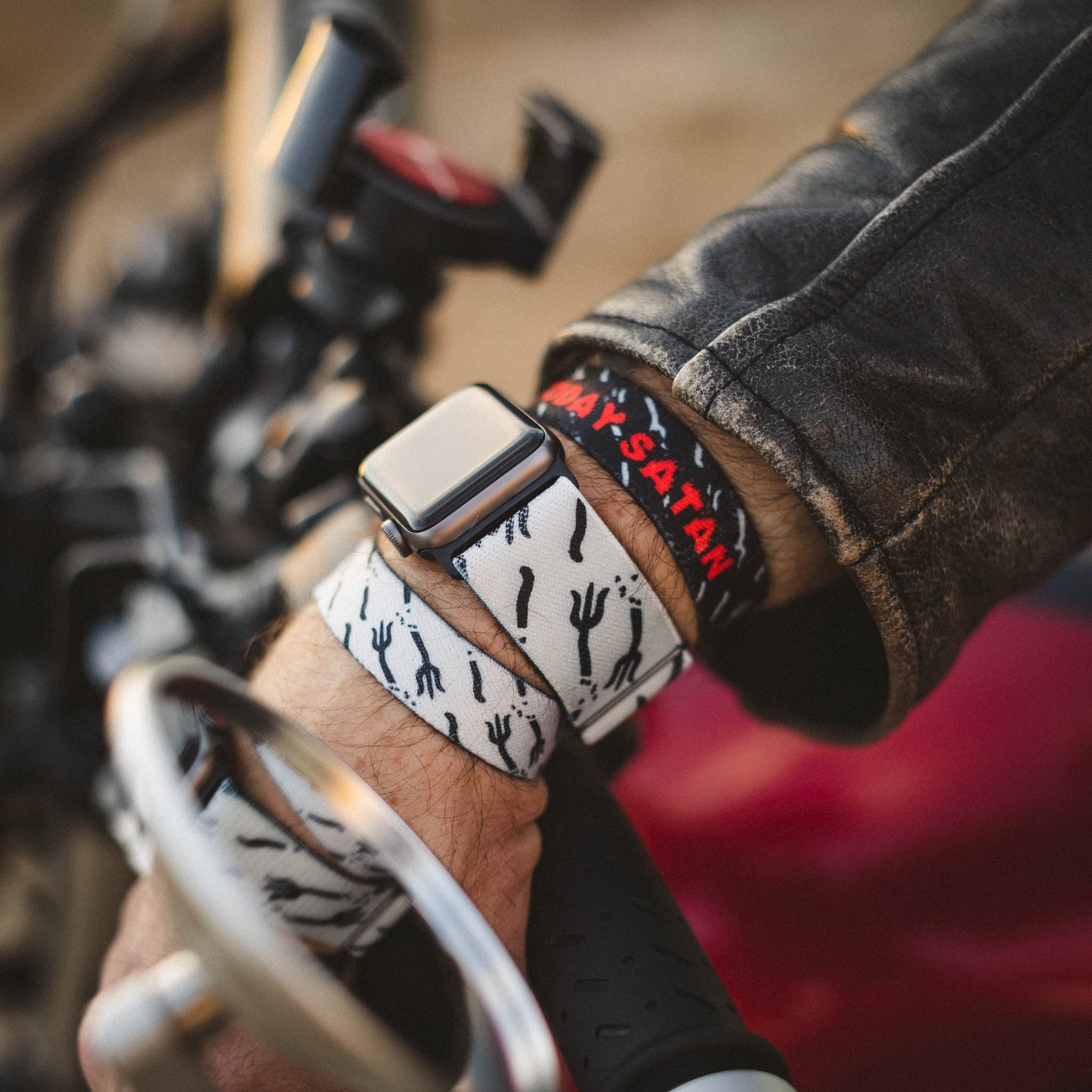 Closeup of someone wearing the wristbands and the watchbands. 