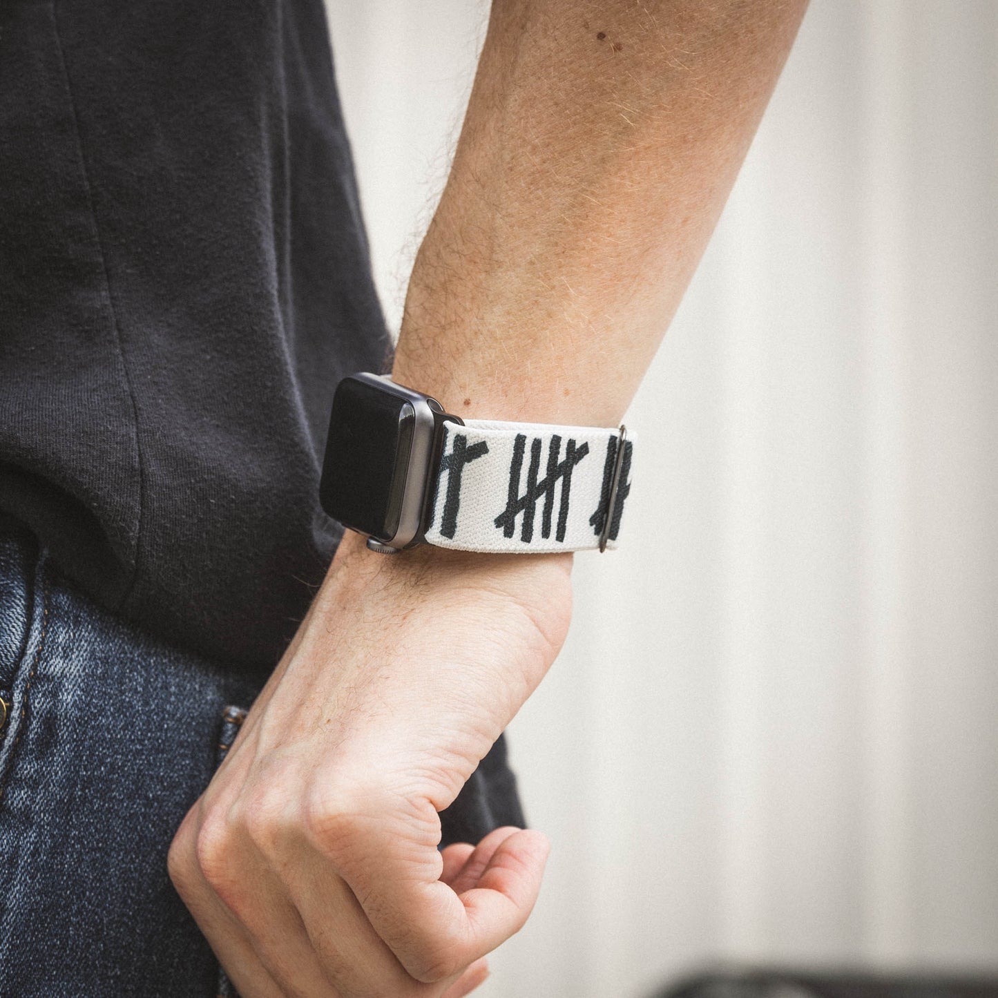 This is a lifestyle photo of an arm wearing the watchband connected to an Apple watch. 