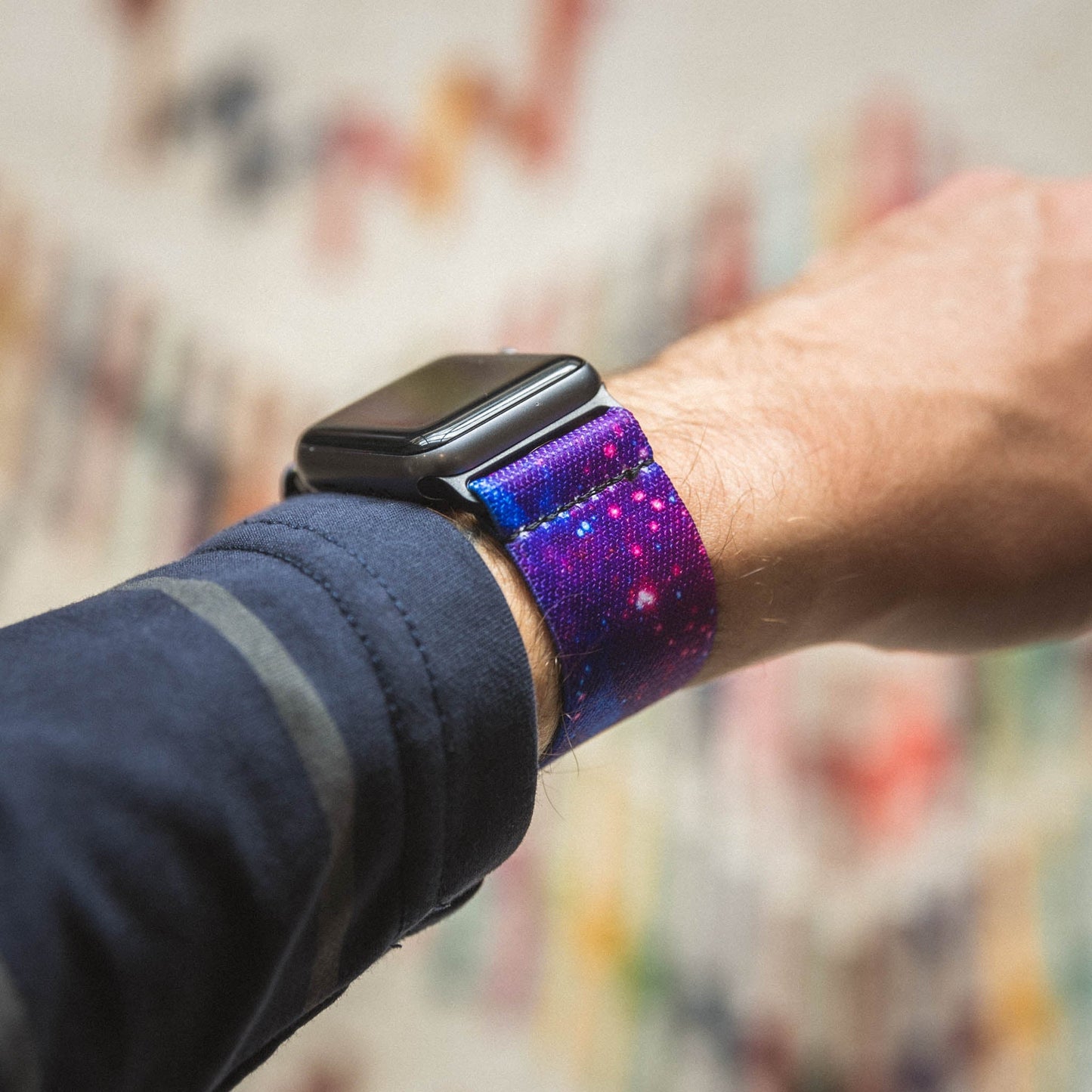 This is a lifestyle photo of someone with a blue shirt wearing the watchband on an Apple watch. 