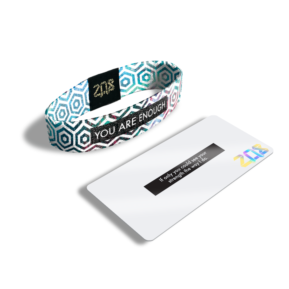 Product photo of the inside of you are enough. It is a white hexagon pattern overlaying a pink, blue, green, and purple galaxy design with white you are enough text over black box and its card that says ‘If only you could see your strength the way I do.’