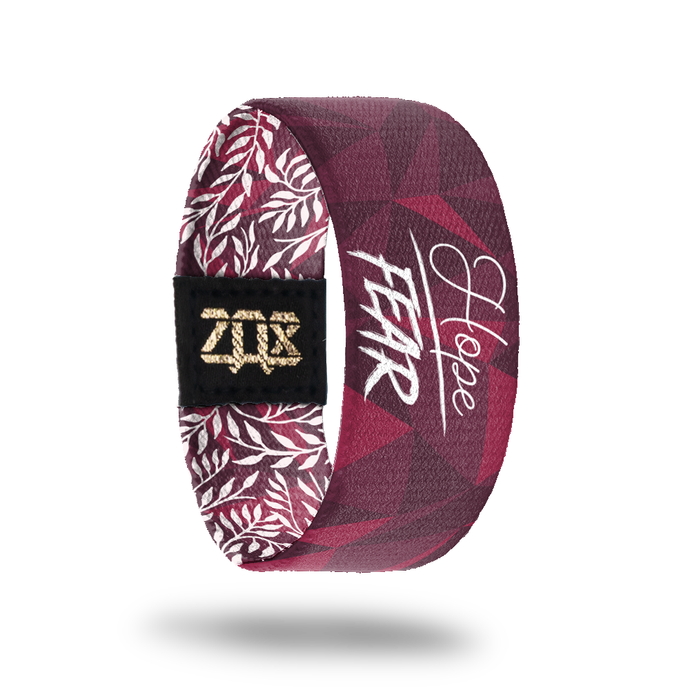 Inside design of Hope Over Fear. Shades of red for the background with subtle geotactic shapes. Centered is Hope in thin white text above a thin white line and Fear in bold white text below the thin white line