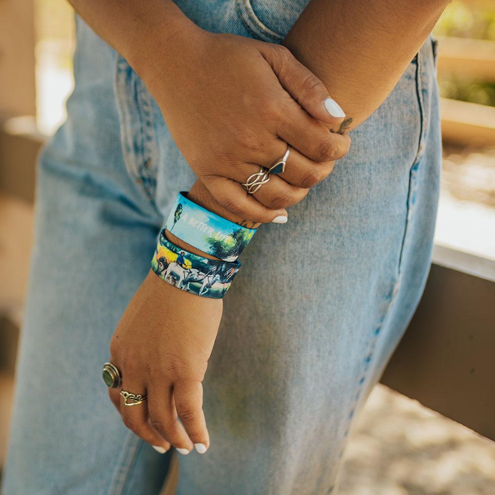 Lifestyle photo of girl wearing rings and 2 A Better Life wristbands