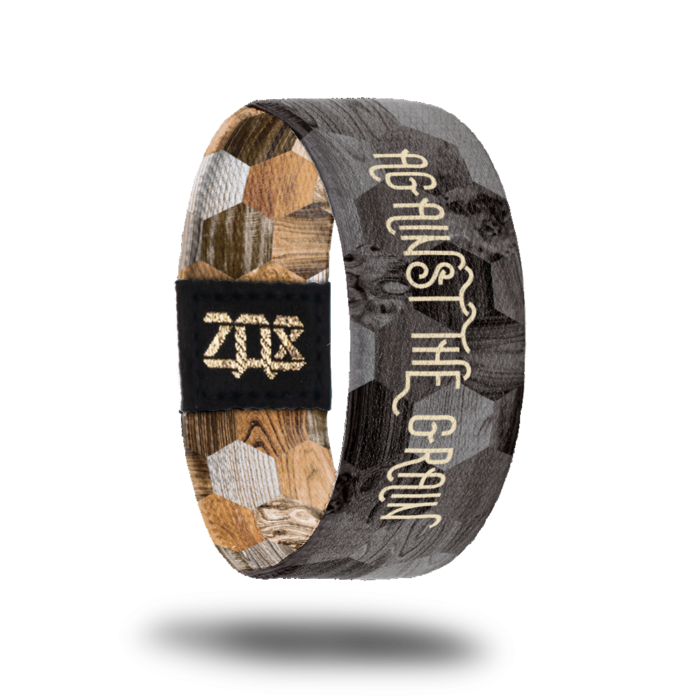 Inside design of Against the Grain : Against the Gain in light brown text. With grayscale version of outside design behind the text. 