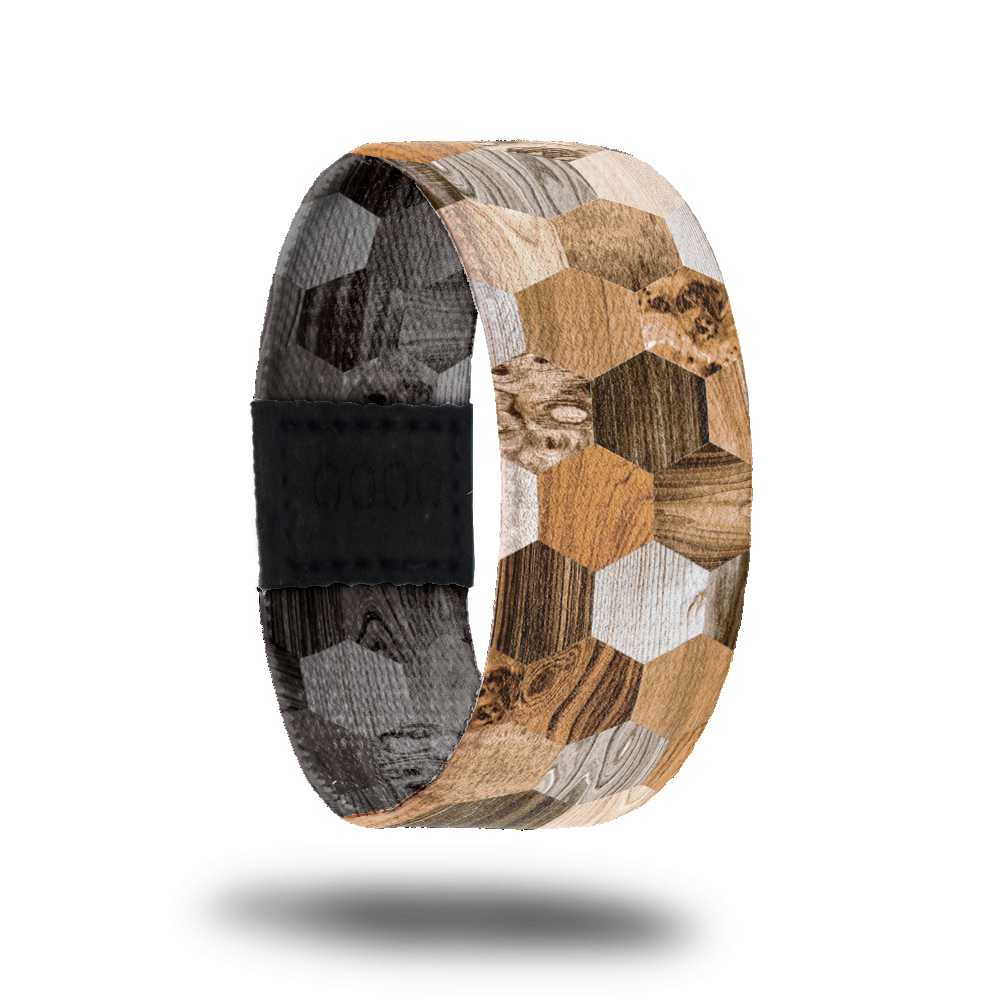 Outside design of Against the Grain: hexagon shapes with a variety of different types of wood grain. 