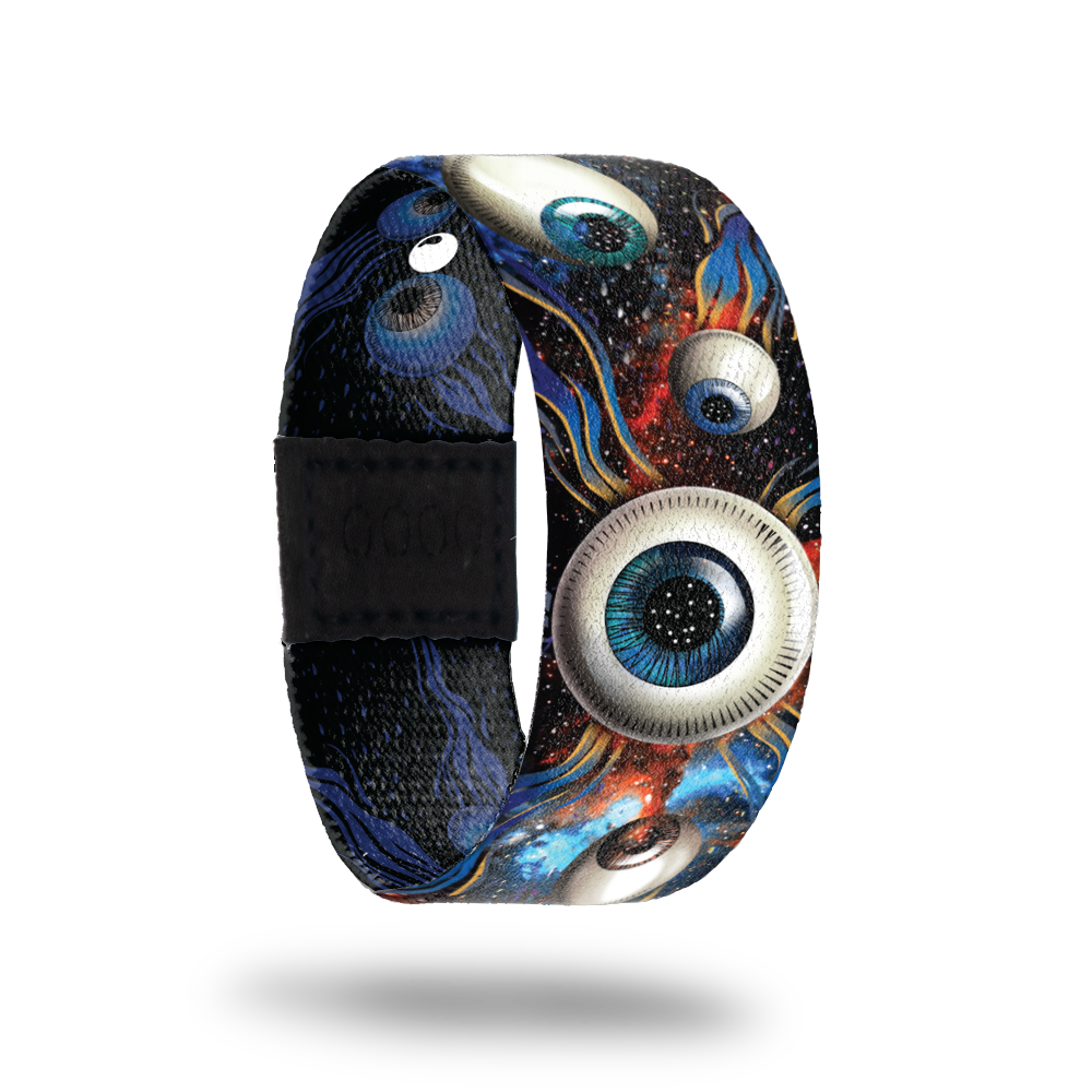 Space background with different colored eyeballs. Inside is the same in a monochromatic color and says All Eyes On Me. Comes with a matching lapel pin. 