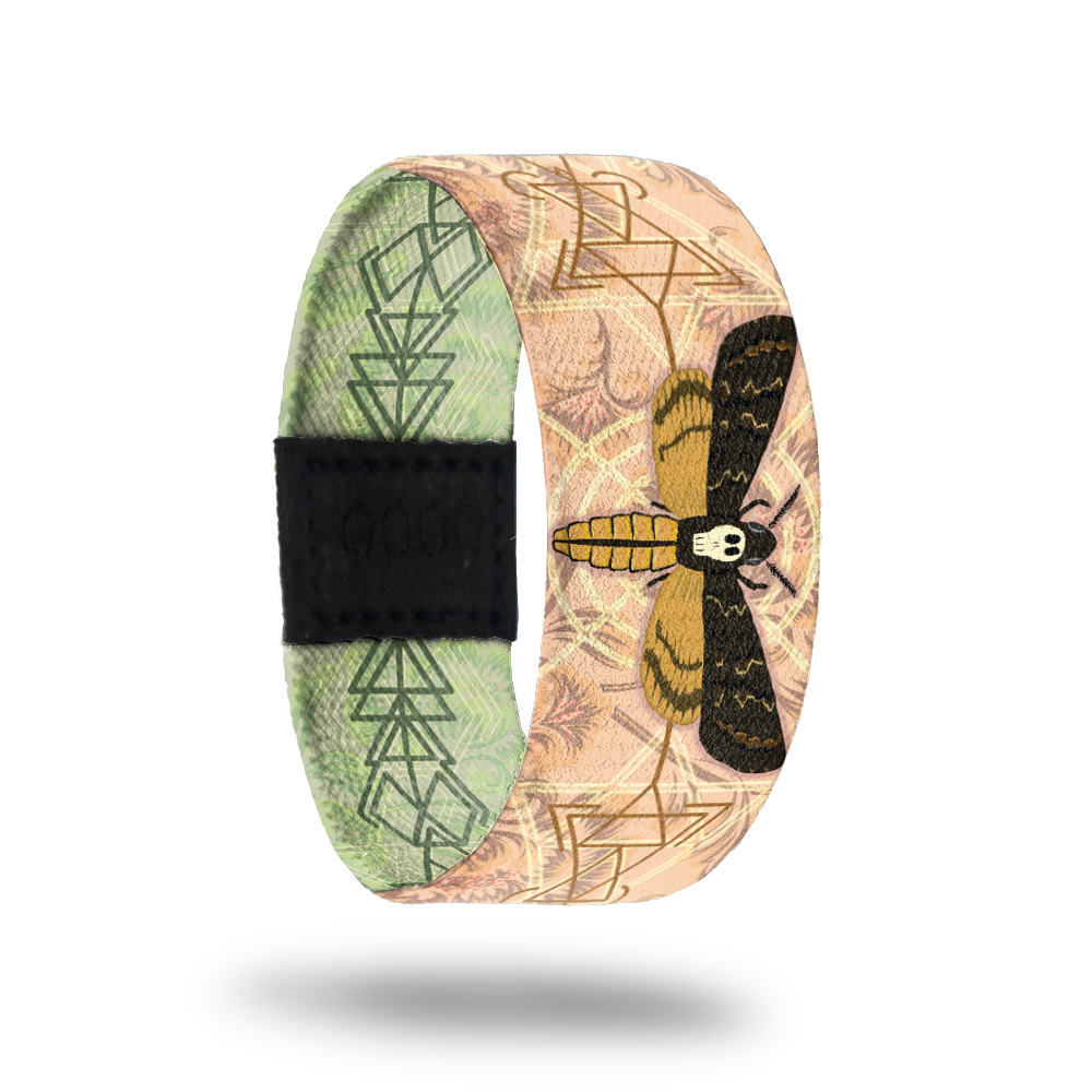 Outside Design of Beauty in Disguise a tan design with cream and brown geometric details with a moth in the center